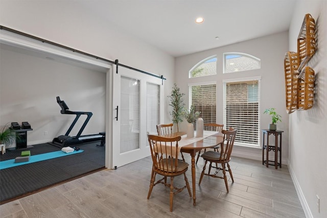 624 Judge Fisk Dr, Leander, TX 78641 - dining space featuring light wood-style floors, a barn door, and recessed lighting