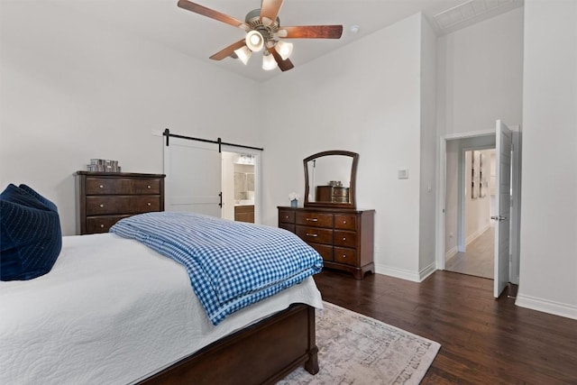 624 Judge Fisk Dr, Leander, TX 78641 - bedroom featuring dark wood-style flooring, high vaulted ceiling, a barn door, ceiling fan, and ensuite bathroom