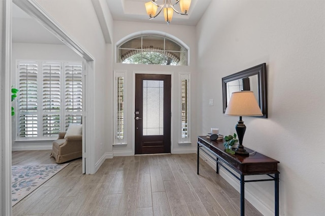 624 Judge Fisk Dr, Leander, TX 78641 - foyer entrance with a chandelier, wood finished floors, and a towering ceiling