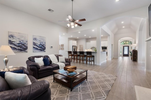 624 Judge Fisk Dr, Leander, TX 78641 - living area featuring arched walkways, a ceiling fan, lofted ceiling, light wood-style flooring, and recessed lighting