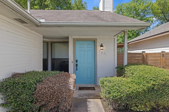 1821 Golden Pheasant Dr, Austin, TX 78758 - entrance to property featuring roof with shingles and a chimney