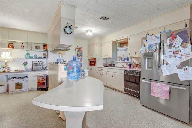 1402 Herder Ave, Schulenburg, TX 78956 - kitchen with stainless steel fridge, dishwasher, light countertops, and open shelves
