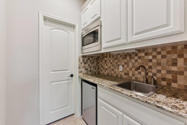 1108 Lakewood Hills Ter, Austin, TX 78732 - kitchen with stainless steel appliances, backsplash, white cabinetry, and light stone counters