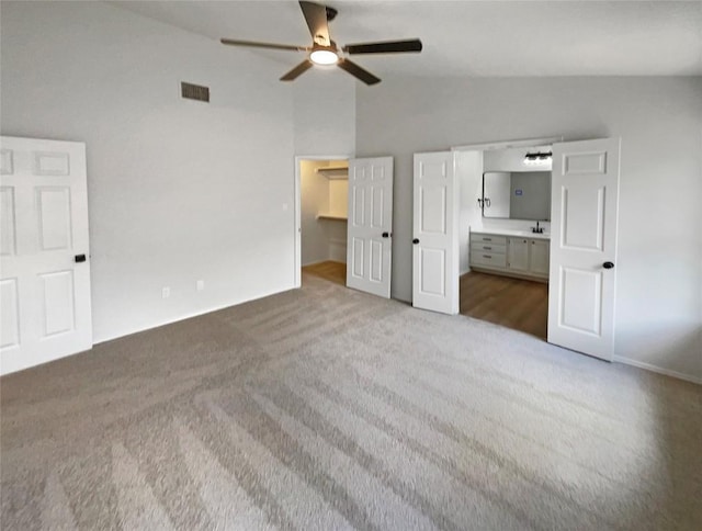 1207 Brashear Ln, Cedar Park, TX 78613 - unfurnished bedroom with vaulted ceiling, carpet, a spacious closet, connected bathroom, and ceiling fan