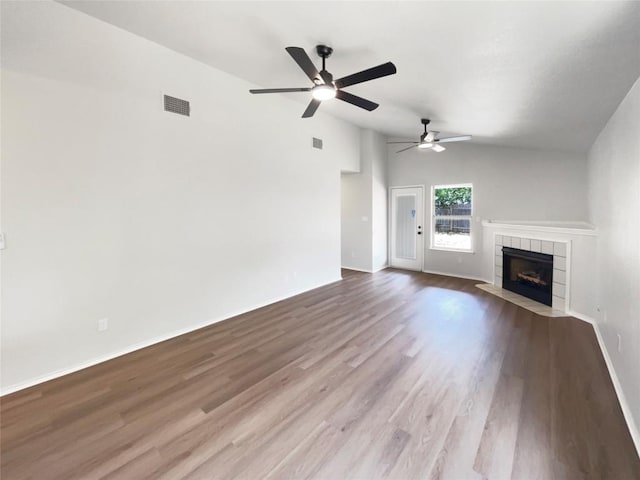 1207 Brashear Ln, Cedar Park, TX 78613 - unfurnished living room featuring a fireplace, ceiling fan, wood finished floors, and vaulted ceiling