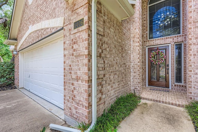 1406 Hunter Ace Way, Cedar Park, TX 78613 - doorway to property featuring a garage, brick siding, and concrete driveway