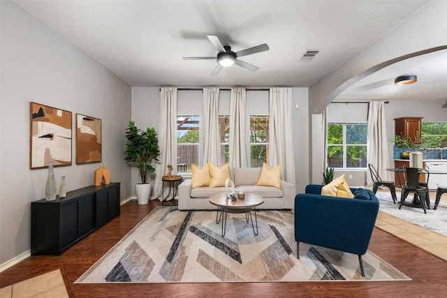 8701 Meridian Oak Ln, Austin, TX 78744 - living area featuring arched walkways, ceiling fan, and wood finished floors
