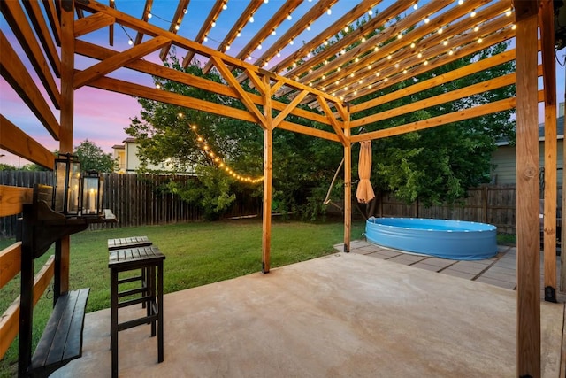 8701 Meridian Oak Ln, Austin, TX 78744 - patio terrace at dusk featuring a hot tub, a fenced backyard, a pergola, and a patio