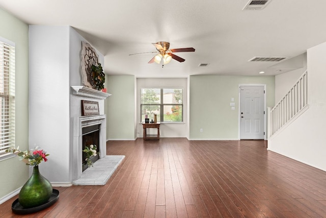 425 Starview St, Temple, TX 76502 - unfurnished living room featuring ceiling fan, a fireplace with raised hearth, stairway, and dark wood-style flooring