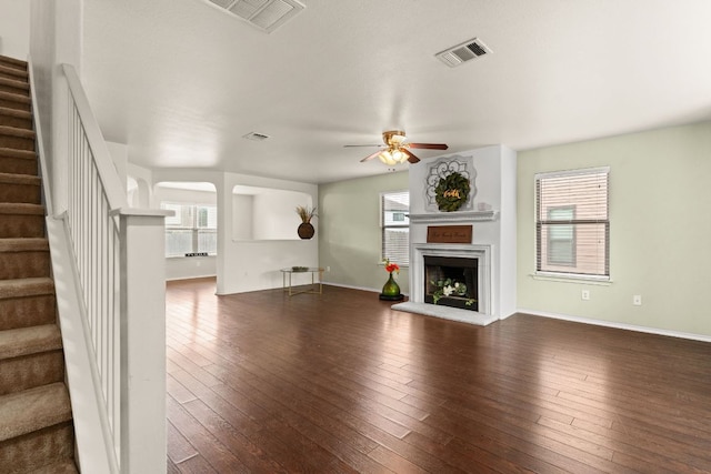 425 Starview St, Temple, TX 76502 - unfurnished living room with a ceiling fan, stairway, a fireplace with raised hearth, and dark wood finished floors
