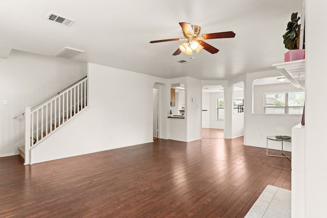 425 Starview St, Temple, TX 76502 - unfurnished living room with arched walkways, ceiling fan, hardwood / wood-style flooring, and stairway