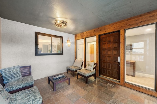 6110 Gardenridge Holw, Austin, TX 78750 - sitting room with stone finish floors, healthy amount of natural light, and wood walls