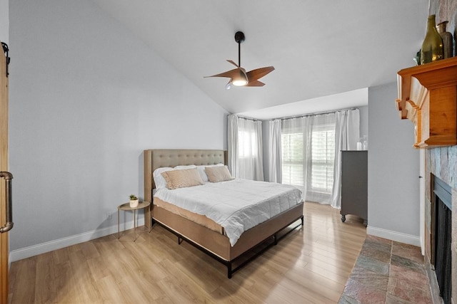 6110 Gardenridge Holw, Austin, TX 78750 - bedroom with a fireplace with flush hearth, light wood-type flooring, vaulted ceiling, and a ceiling fan
