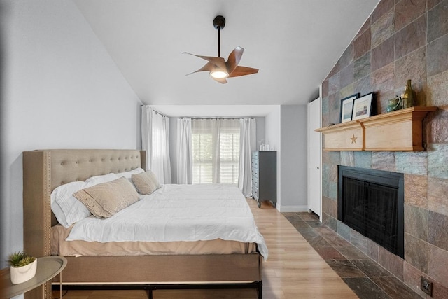 6110 Gardenridge Holw, Austin, TX 78750 - bedroom featuring vaulted ceiling, a fireplace, wood finished floors, and a ceiling fan