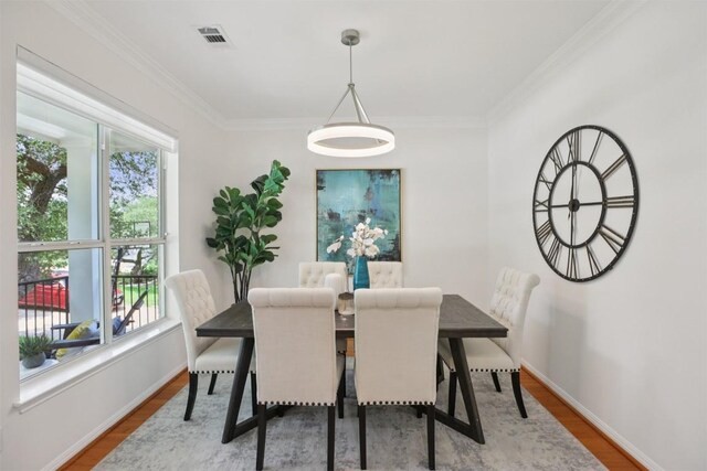 6520 Walebridge Ln, Austin, TX 78739 - dining room with healthy amount of natural light, wood finished floors, and crown molding