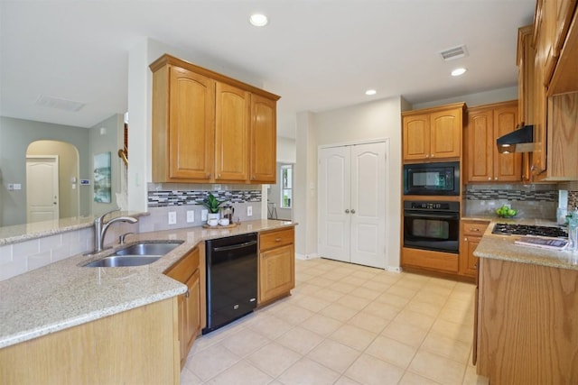 6520 Walebridge Ln, Austin, TX 78739 - kitchen featuring black appliances, tasteful backsplash, light stone countertops, under cabinet range hood, and arched walkways