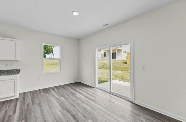 127 Bridgeview Dr, Hutto, TX 78634 - unfurnished living room with wood finished floors and baseboards