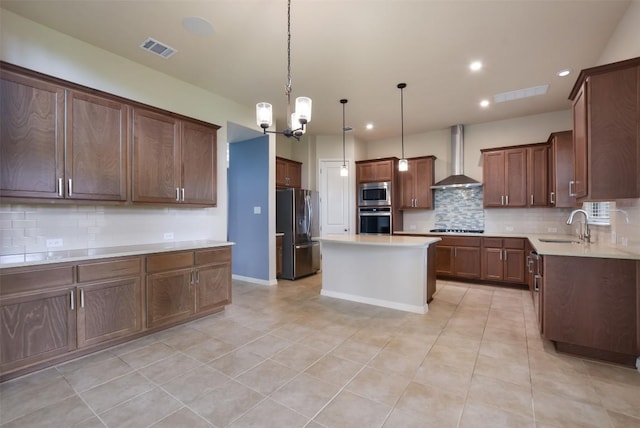 19908 Eire Dr, Pflugerville, TX 78660 - kitchen featuring stainless steel appliances, wall chimney range hood, backsplash, a center island, and recessed lighting