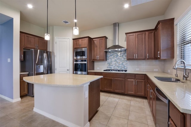 19908 Eire Dr, Pflugerville, TX 78660 - kitchen with wall chimney range hood, stainless steel appliances, backsplash, a kitchen island, and light tile patterned floors