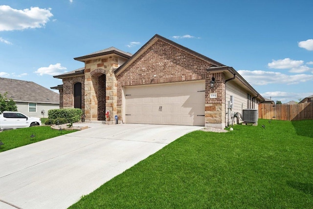 184 Pivot Dr, Taylor, TX 76574 - view of front of house featuring stone siding, an attached garage, concrete driveway, and brick siding