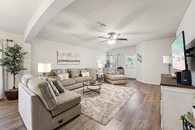 184 Pivot Dr, Taylor, TX 76574 - living room featuring arched walkways, a ceiling fan, and wood finished floors