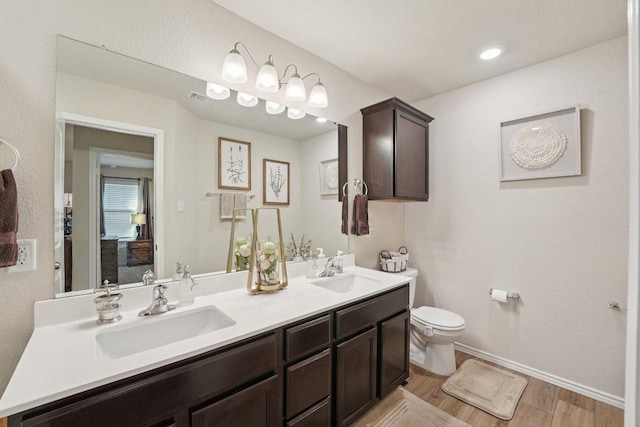 184 Pivot Dr, Taylor, TX 76574 - bathroom featuring double vanity and wood finished floors