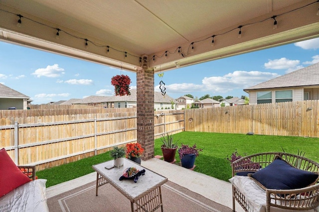 184 Pivot Dr, Taylor, TX 76574 - fenced backyard with a patio area, a residential view, and an outdoor living space