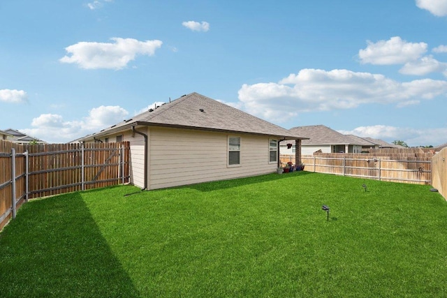 184 Pivot Dr, Taylor, TX 76574 - back of house with a fenced backyard and a shingled roof