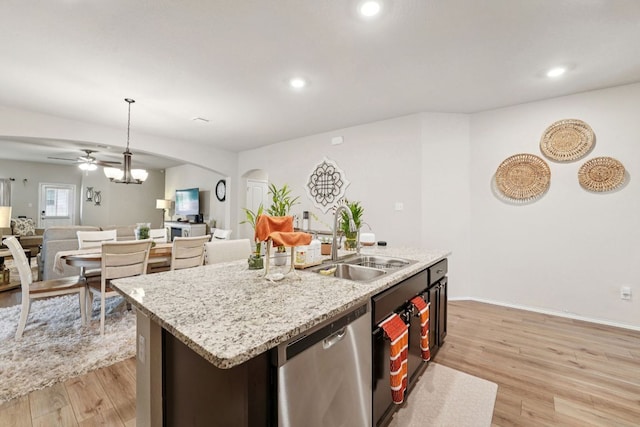 184 Pivot Dr, Taylor, TX 76574 - kitchen featuring stainless steel dishwasher, arched walkways, light wood finished floors, open floor plan, and a ceiling fan