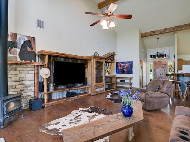 762 Karisch Rd, Giddings, TX 78942 - living area featuring a wood stove, high vaulted ceiling, finished concrete flooring, ceiling fan, and beam ceiling