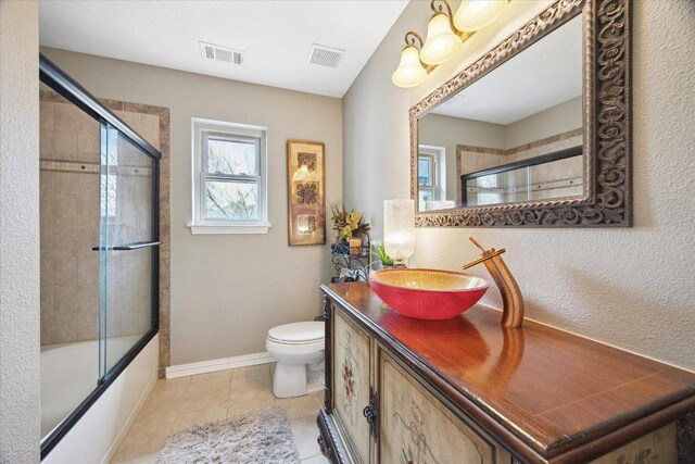 515 Wesley Ridge Dr, Spicewood, TX 78669 - bathroom with vanity, enclosed tub / shower combo, and tile patterned floors