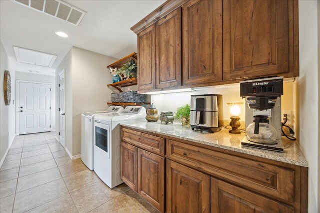 515 Wesley Ridge Dr, Spicewood, TX 78669 - laundry room with washing machine and dryer, light tile patterned flooring, cabinet space, and recessed lighting
