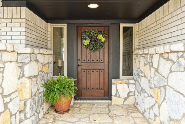 515 Wesley Ridge Dr, Spicewood, TX 78669 - doorway to property featuring stone siding and a porch