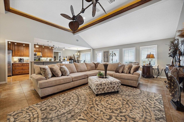 515 Wesley Ridge Dr, Spicewood, TX 78669 - living room featuring a ceiling fan, light tile patterned flooring, ornamental molding, rail lighting, and a chandelier