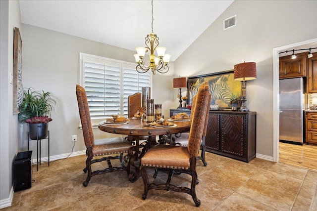 515 Wesley Ridge Dr, Spicewood, TX 78669 - dining area with a chandelier and vaulted ceiling