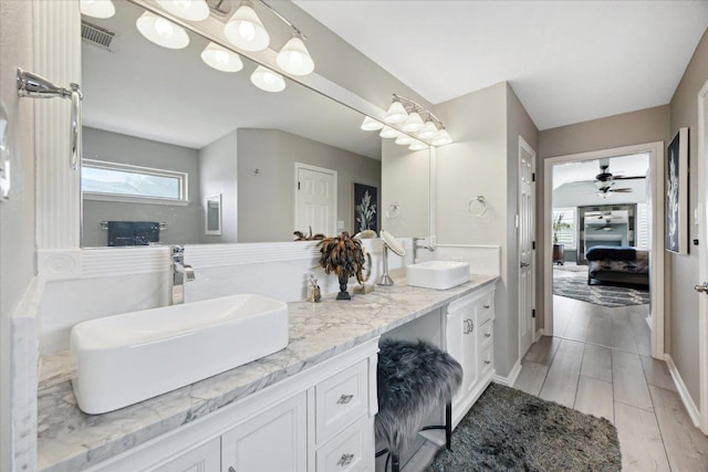 515 Wesley Ridge Dr, Spicewood, TX 78669 - ensuite bathroom featuring double vanity, a ceiling fan, and wood finished floors