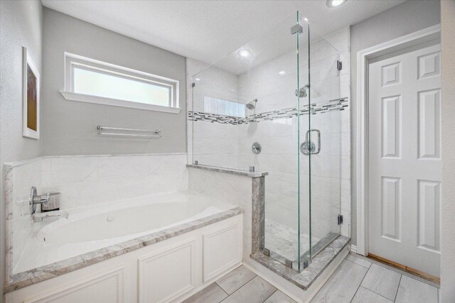 515 Wesley Ridge Dr, Spicewood, TX 78669 - bathroom featuring a bath, a shower stall, and recessed lighting