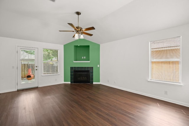 14608 Menifee St, Austin, TX 78725 - unfurnished living room featuring a ceiling fan, vaulted ceiling, wood finished floors, and a tiled fireplace