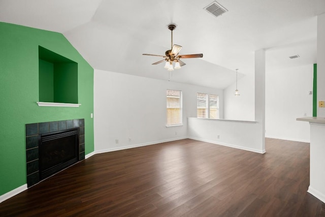 14608 Menifee St, Austin, TX 78725 - unfurnished living room featuring lofted ceiling, a tiled fireplace, a ceiling fan, and wood finished floors