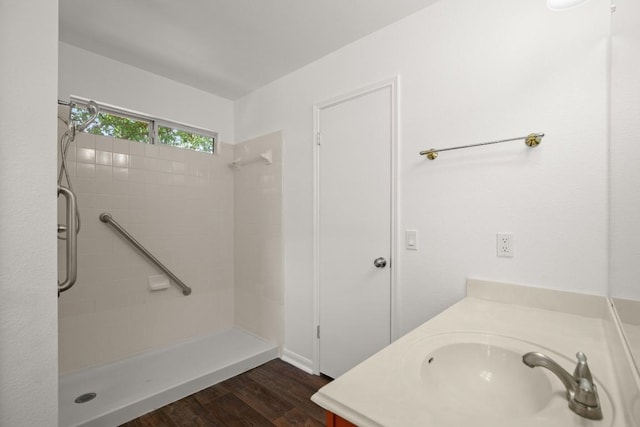 14608 Menifee St, Austin, TX 78725 - full bath featuring a tile shower, wood finished floors, and vanity