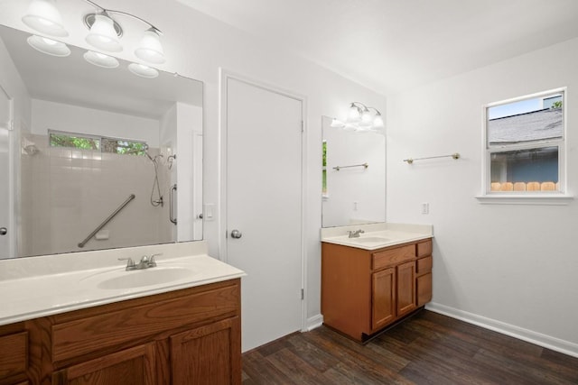 14608 Menifee St, Austin, TX 78725 - full bath with two vanities, wood finished floors, and a shower