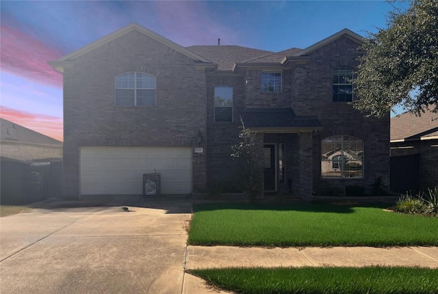 4522 Heritage Well Ln, Round Rock, TX 78665 - traditional home featuring an attached garage, concrete driveway, a yard, and brick siding