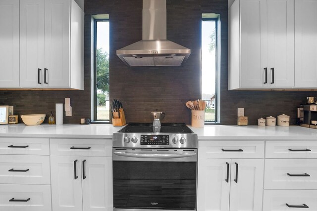809 John Price, Blanco, TX 78606 - kitchen featuring stainless steel electric range oven, ventilation hood, tasteful backsplash, and light countertops