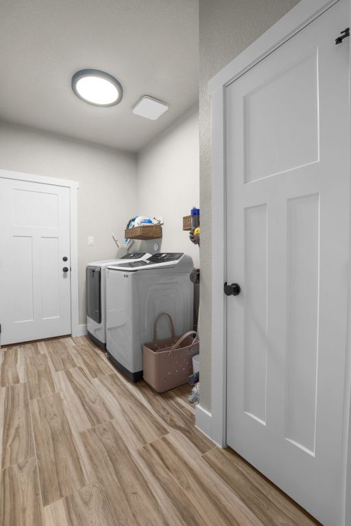 809 John Price, Blanco, TX 78606 - laundry room featuring washer and clothes dryer and light wood finished floors