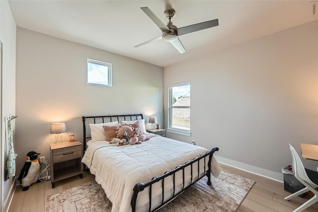 14708 Longbranch Dr, Austin, TX 78734 - bedroom with multiple windows, wood finished floors, and a ceiling fan
