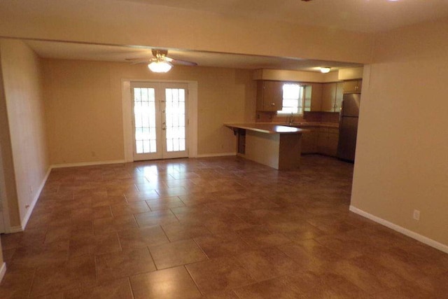 729 Yegua Dr, Lexington, TX 78947 - kitchen with a peninsula, ceiling fan, freestanding refrigerator, french doors, and open floor plan