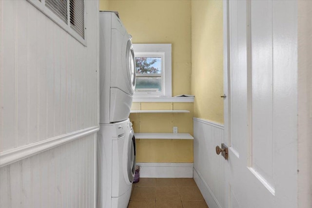 710 Gresham St, Smithville, TX 78957 - laundry room with stacked washer and clothes dryer and tile patterned floors
