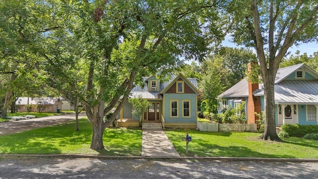 710 Gresham St, Smithville, TX 78957 - view of front facade featuring a porch and a metal roof