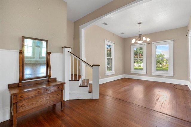 710 Gresham St, Smithville, TX 78957 - foyer featuring wood-type flooring, stairway, healthy amount of natural light, and a chandelier