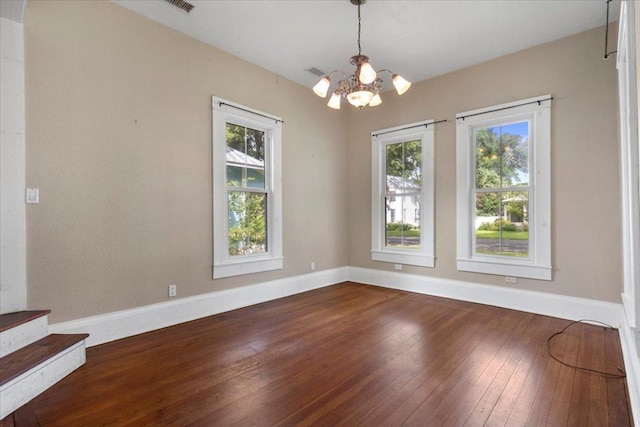 710 Gresham St, Smithville, TX 78957 - spare room with a chandelier, dark wood-style flooring, and stairs